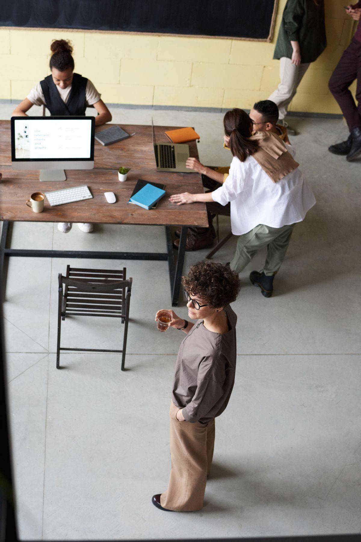 Team collaborating in an open office with laptops and documents